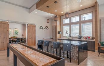 A large kitchen with a bar and a dining table